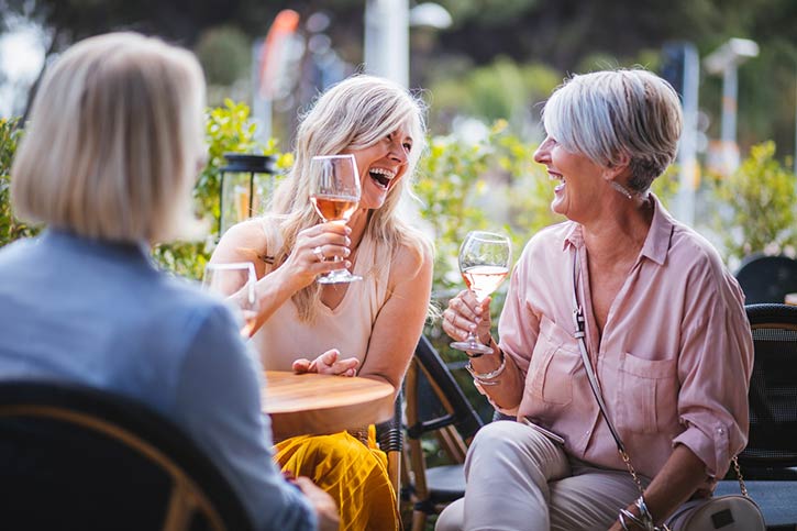 Women Drinking Wine And Laughing