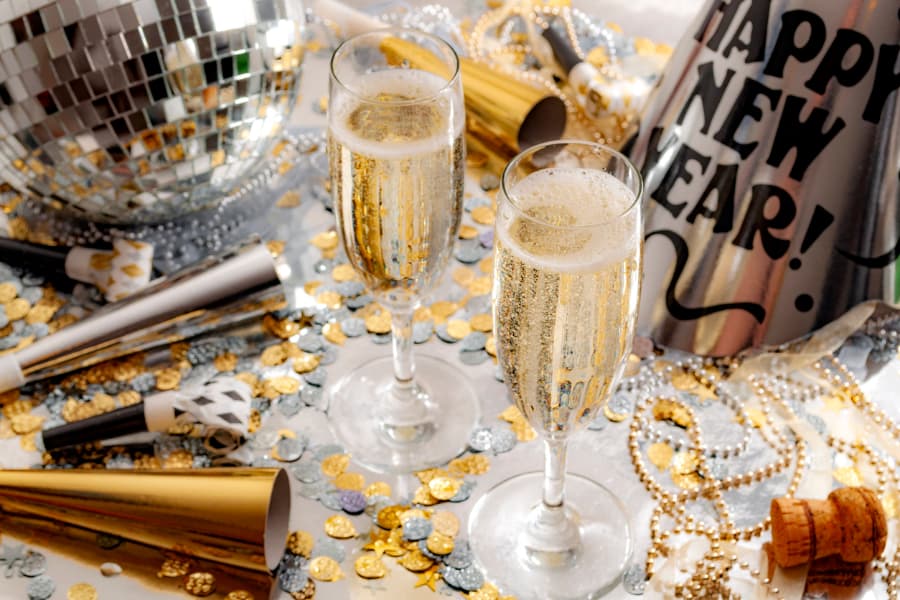 Champagne flutes with New Year’s decorations