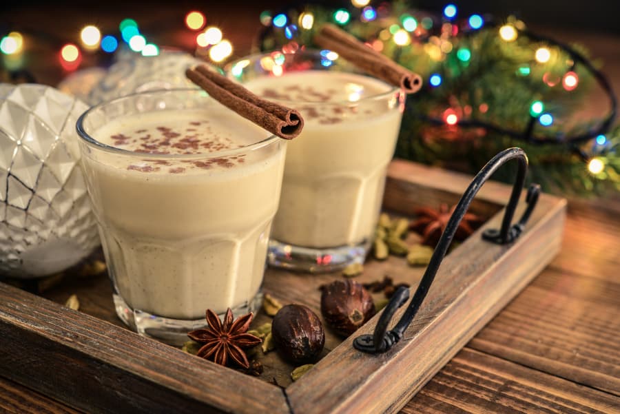 Eggnog on tray with holiday lights in background