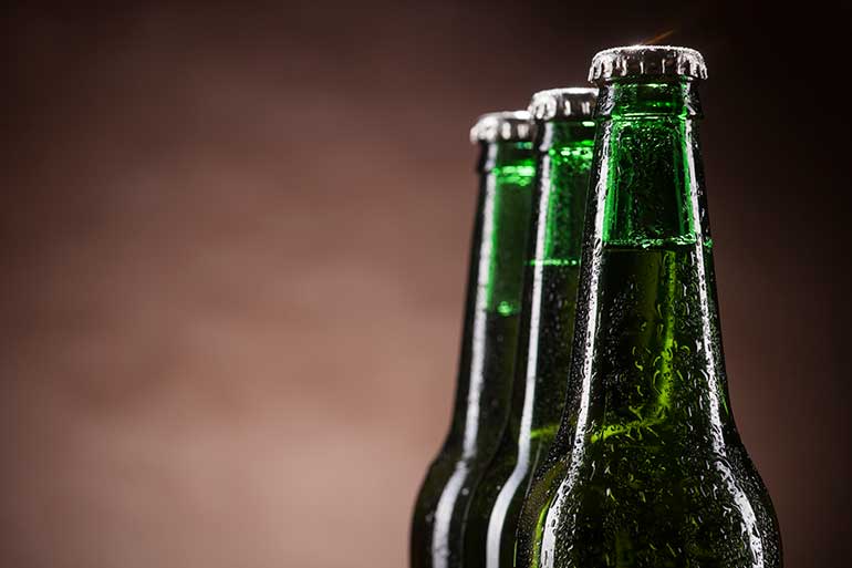 three green beer bottles