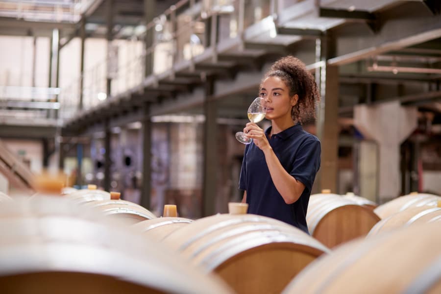 Woman Tastes a Glass of Wine