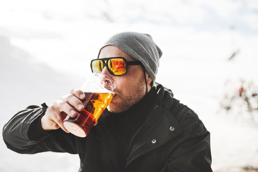 Man With Winter Hat Drinking Outside