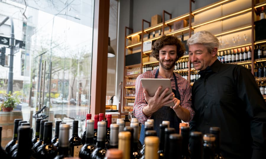 Store Owner And Employee Discuss Online Ordering