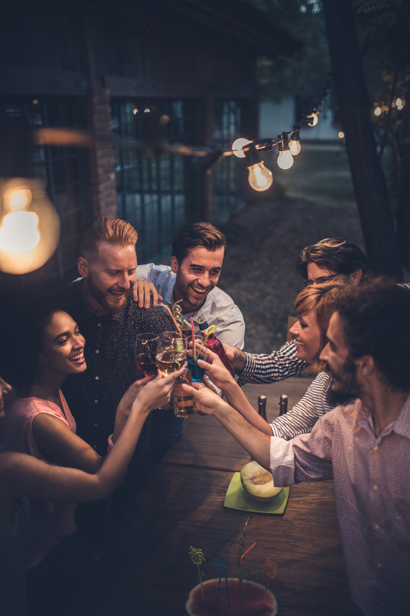 Friends toasting drinks outside