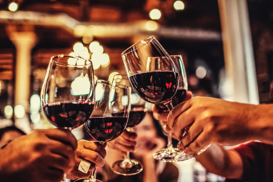 Closeup of wine glasses toasting in celebration