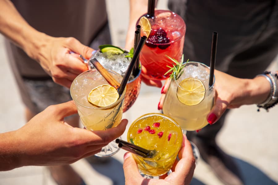 Closeup of five mocktails being toasted