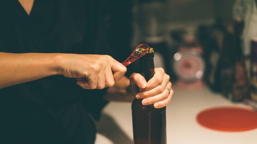 Woman opening bottle of beer