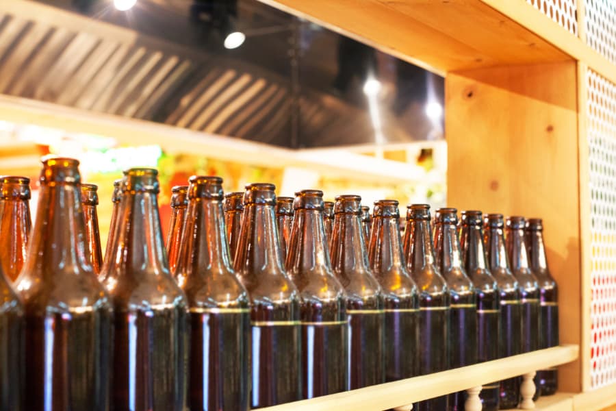 Beer bottles on wooden shelf