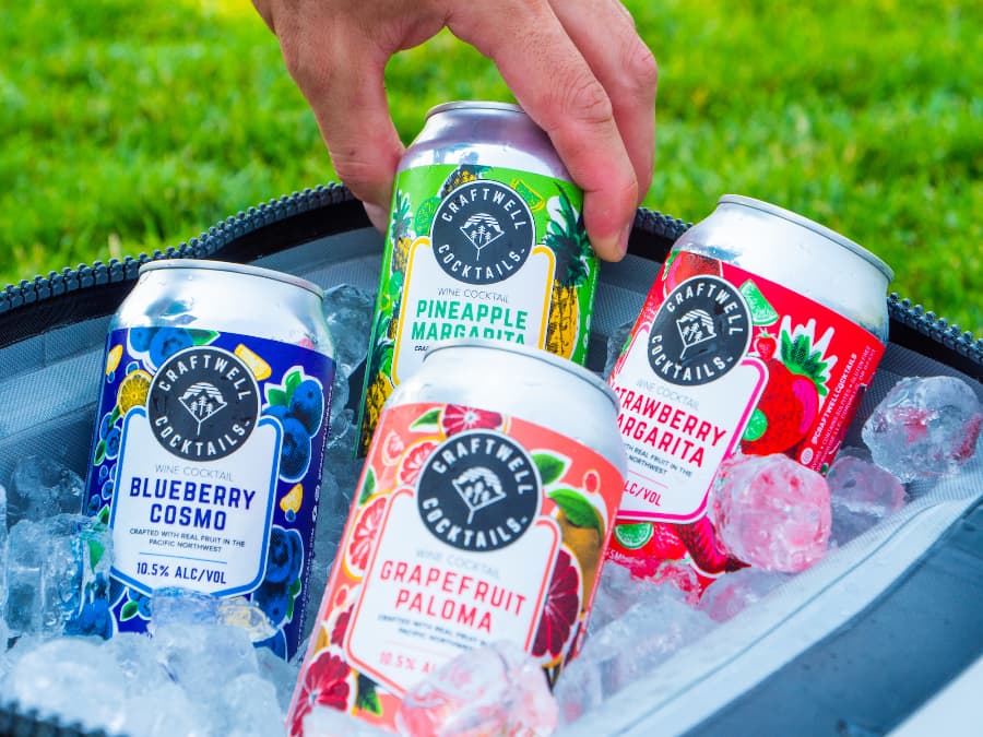 Variety of canned Craftwell Cocktails in a cooler