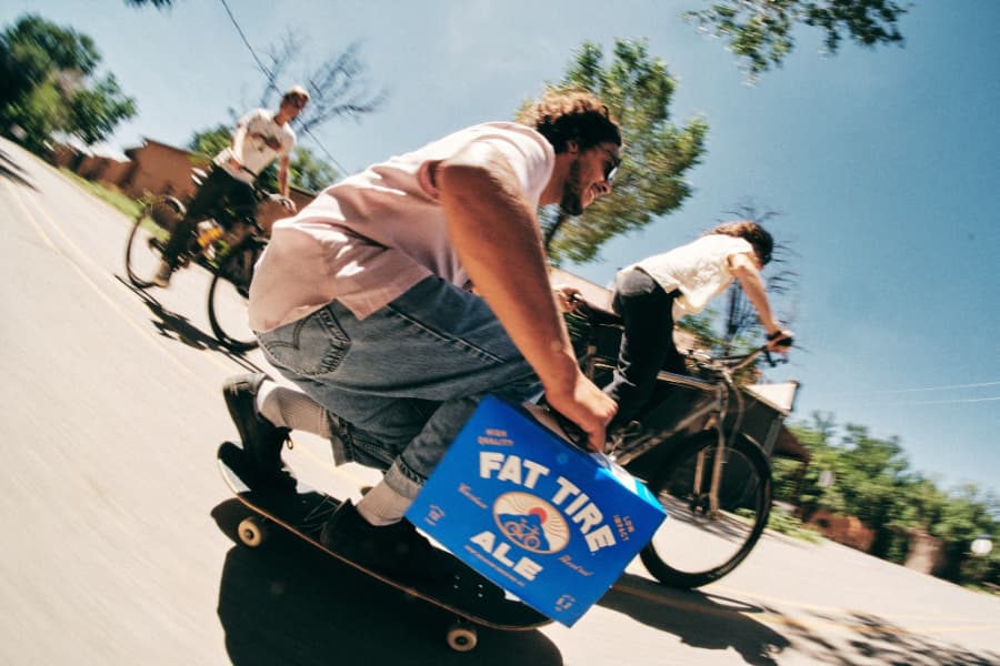 Man skateboarding with New Belgium Fat Tire Ale