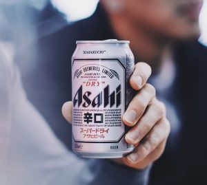 Hang holding Asahi beer can 